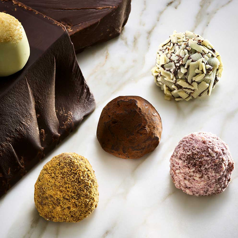 Assorted Godiva chocolate truffles on a marble surface