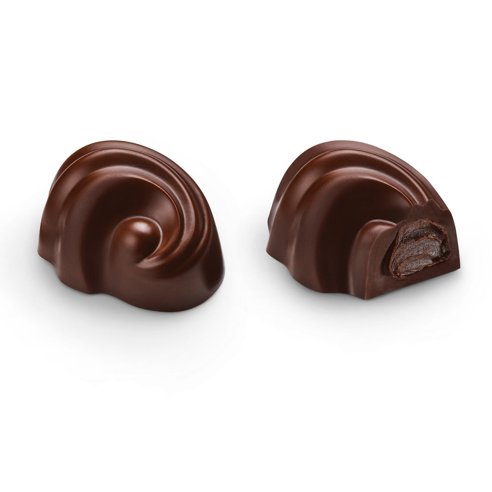Two chocolate truffles on a white background