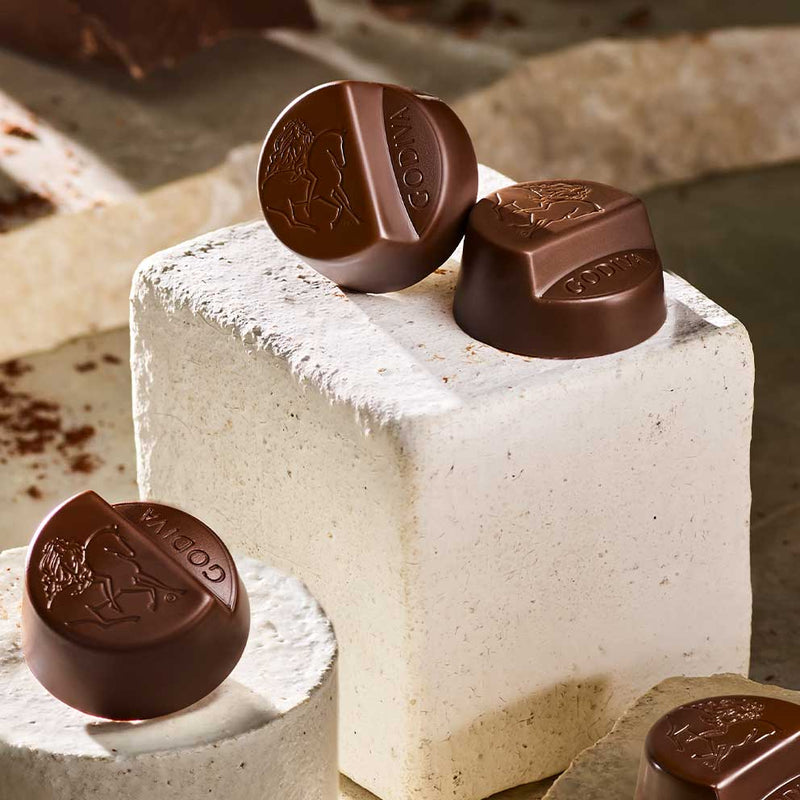 Godiva Masterpiece chocolate on top of a block of stone blocks.