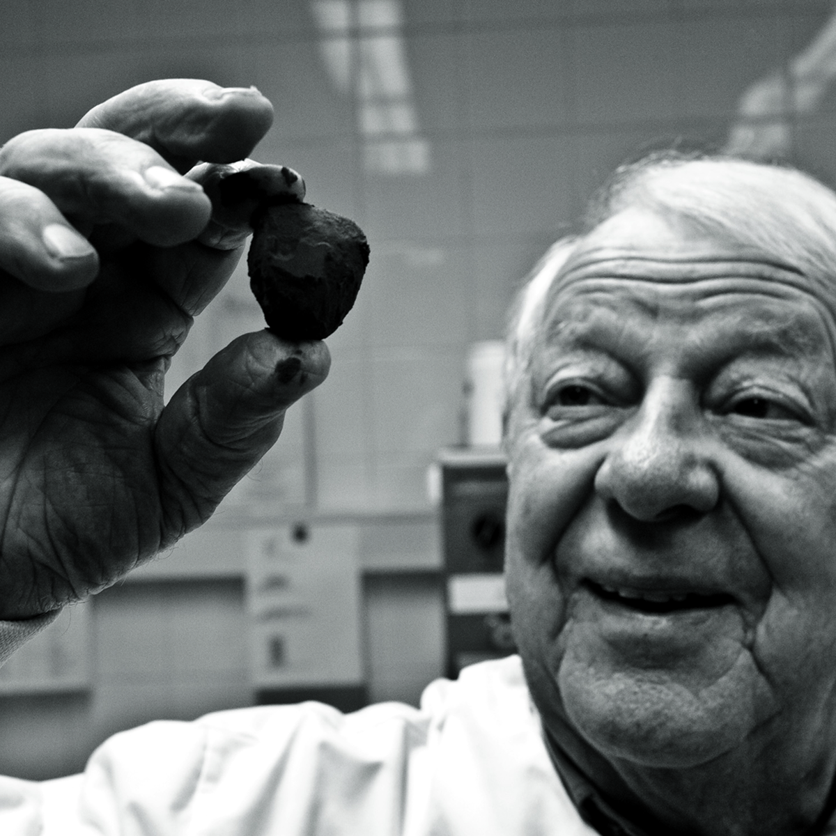 Man holding up a piece of chocolate