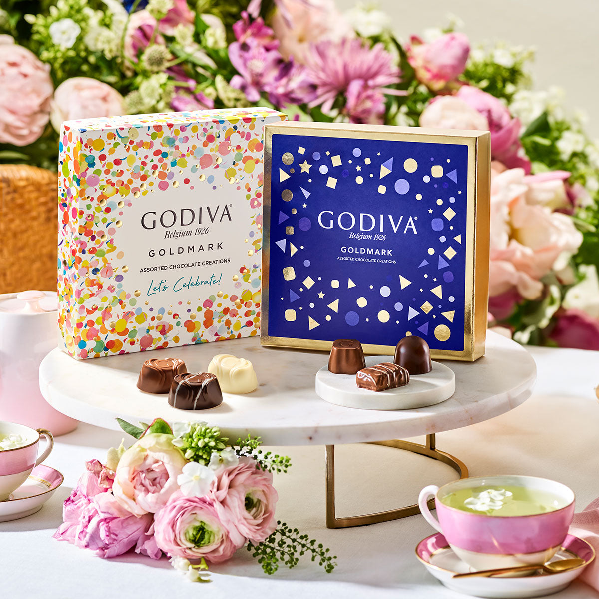 Godiva Goldmark chocolate boxes with chocolates with a floral background