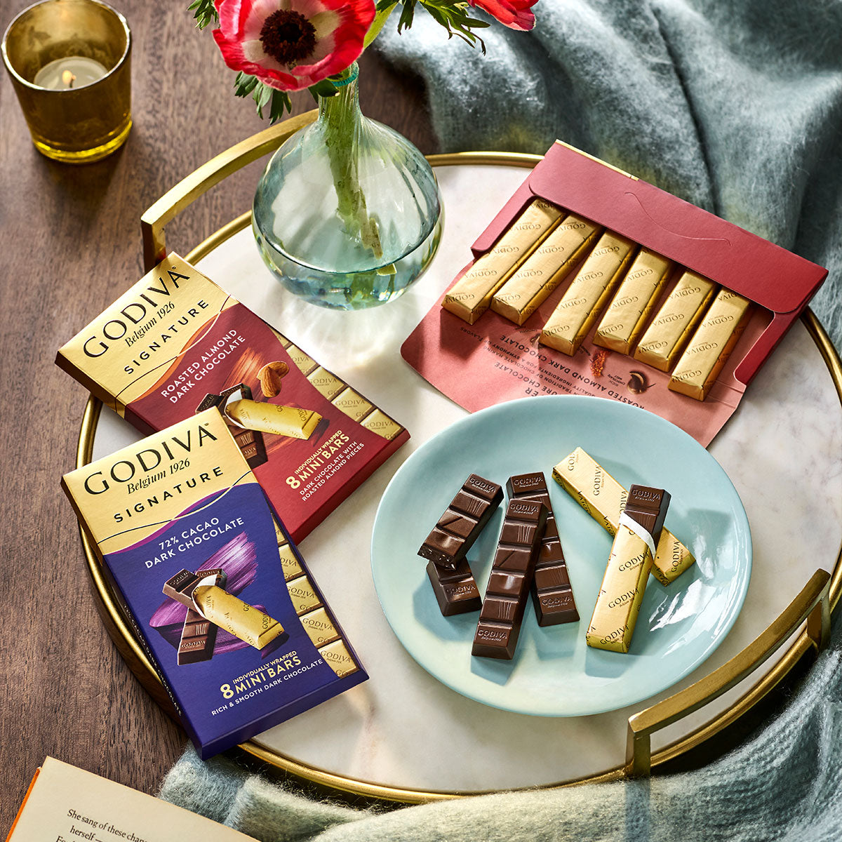 Godiva chocolate bars on a gold serving platter