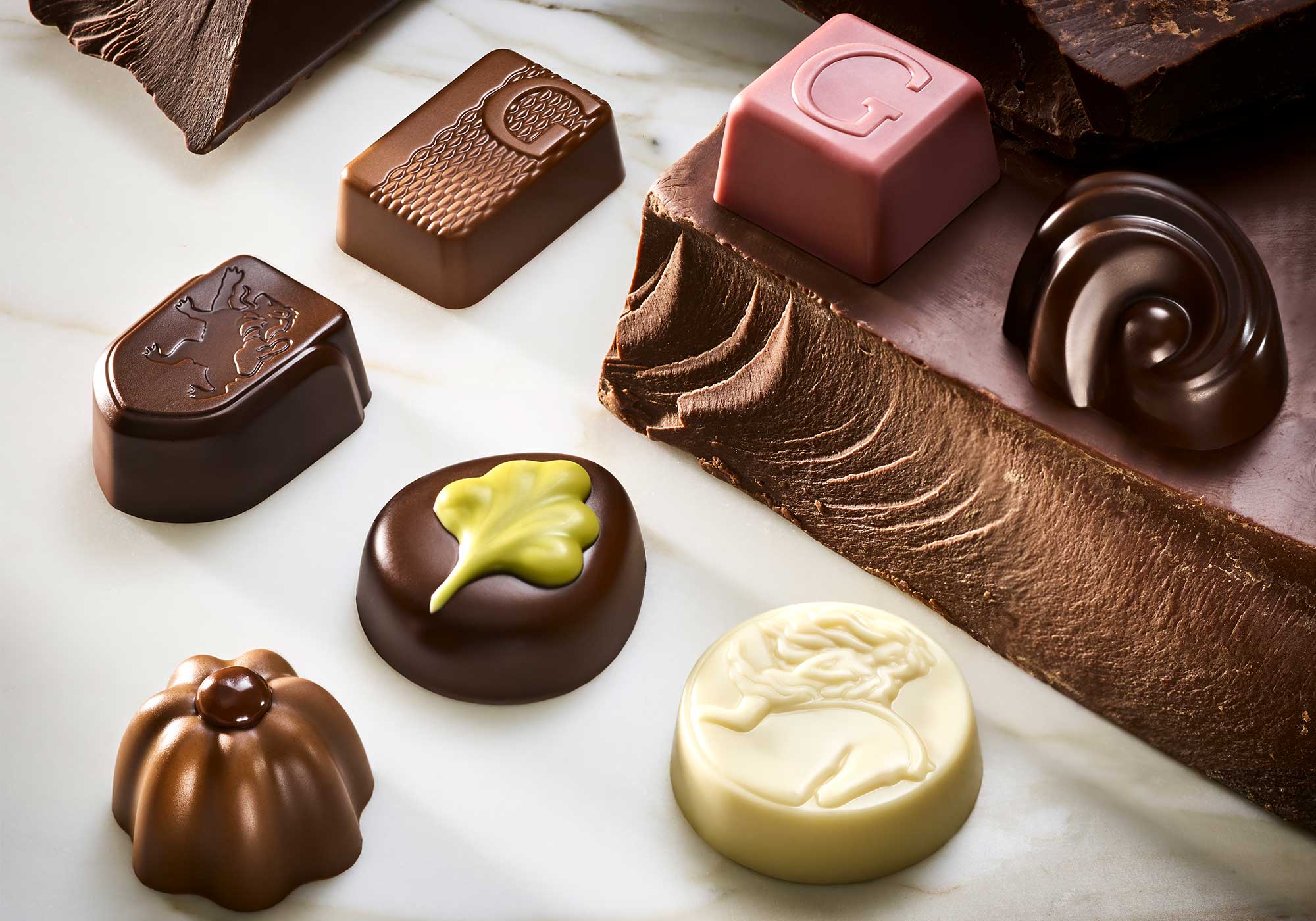Assorted Godiva chocolates on a marble surface