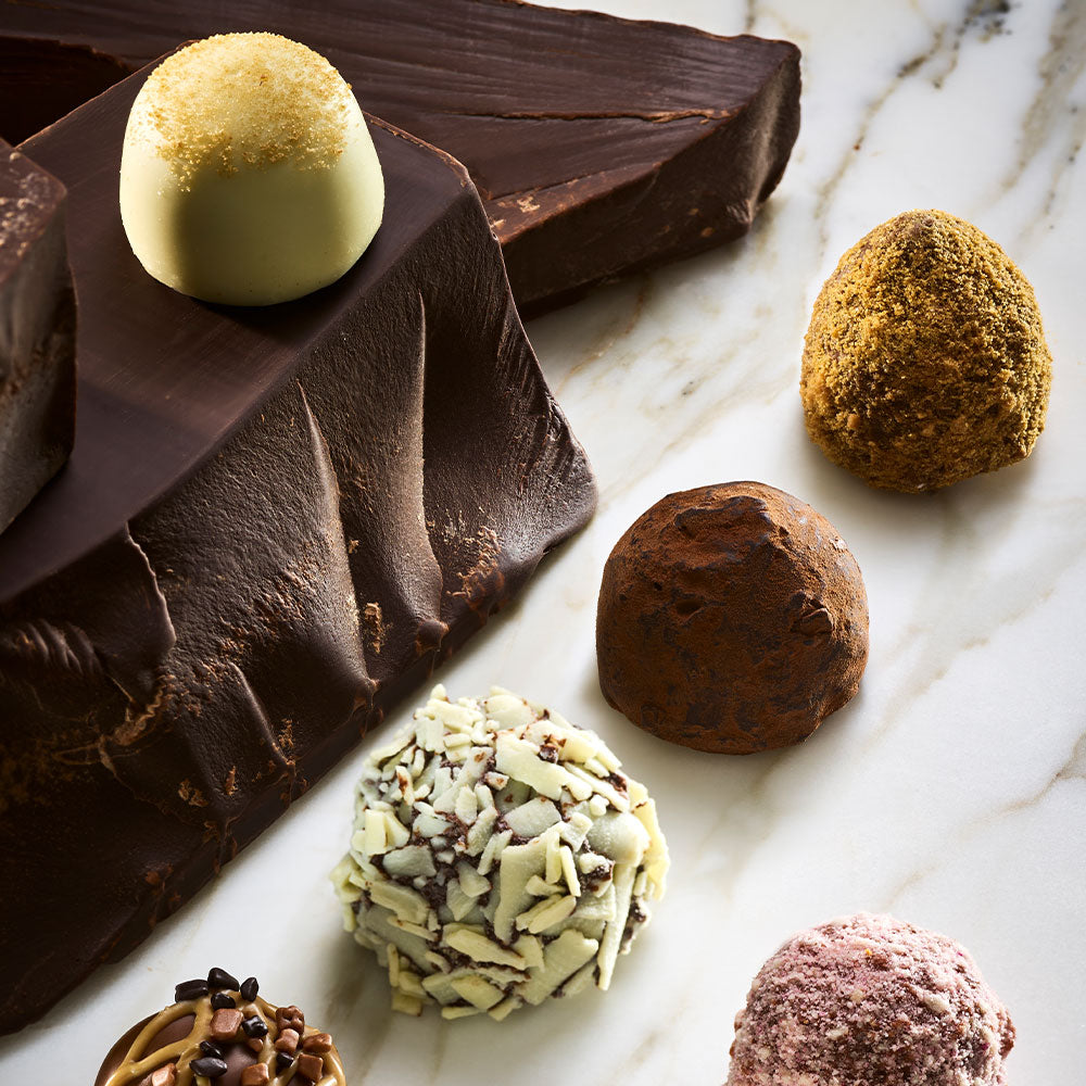 Assorted Godiva chocolate truffles on a marble surface